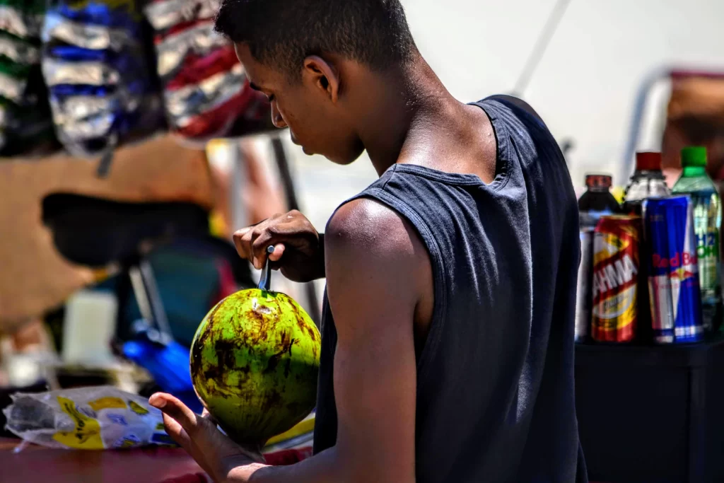 a_boy_opening_a-coconut_in_rio-1024x683