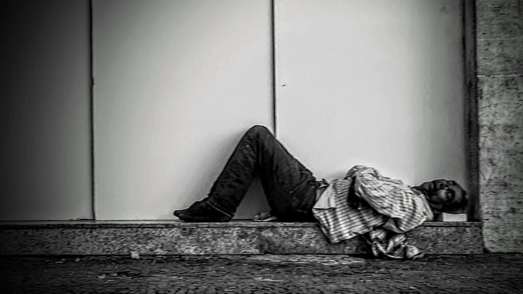homeless_man_lying_in_the_stret_in_rio