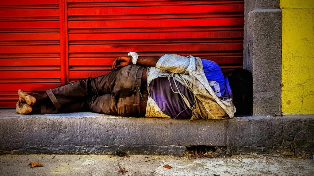 homeless_man_sleeping_in_the_street_in_rocha_rio