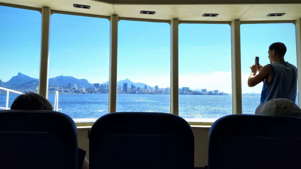 man_taking_a-photo_of_guanabara_bay_from_therio_niteroi_ferry-1024x576